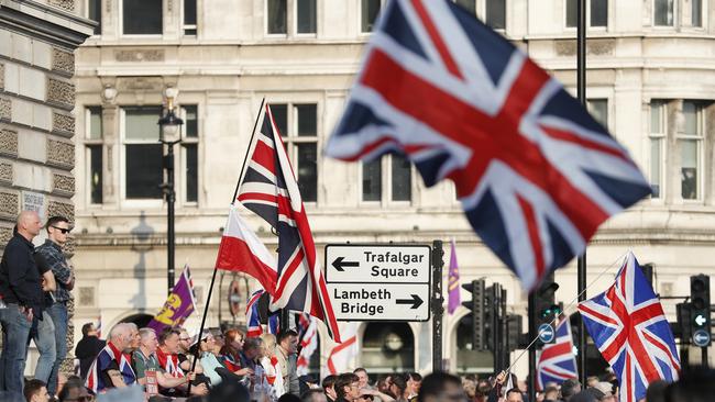 Protester wave British union flags as people gather near parliament during Brexit demonstrations in London on Friday. Picture: AP