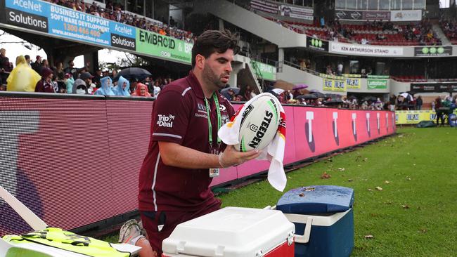 A Manly official disinfects a ball after going into the crowd during an NRL game in March. Picture: Brett Costello