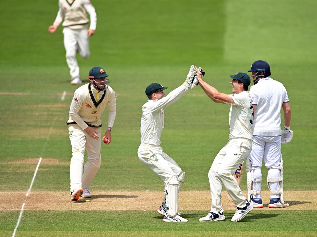 Alex Carey celebrates his run out with Pat Cummins. Picture: Stu Forster/Getty Images.