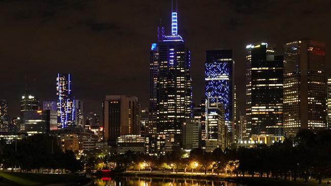 Many of the city’s building turned blue in tribute to the police who lost their lives. Picture: AAP