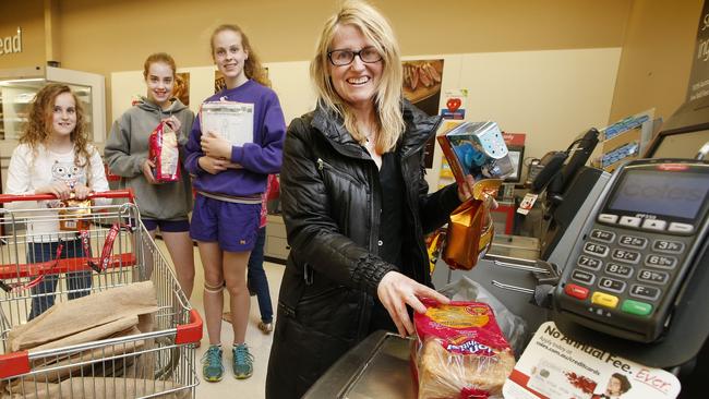 Self-checkouts survey. McBurney family shopping at Coles South Melbourne using the self serve check-out. Mum Janette with kids Emily 10, Juliet 13, and Larissa 14 kids using self-checkout at Coles South Melbourne Picture: David Caird.