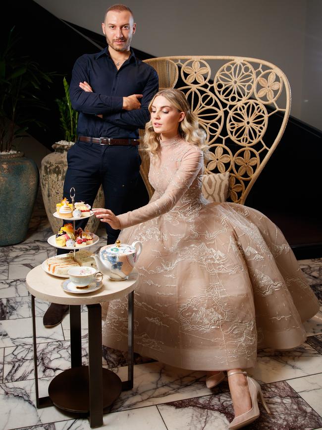 Paul Vasileff with model Georgia Bess from Finesse, serving high tea at the Mayfair Hotel. Paul's label Paolo Sebastian, will be joining forces with the prestigious Mayfair hotel to host two glamorous and intimate high tea events to celebrate Vogue Festival. Picture MATT TURNER.