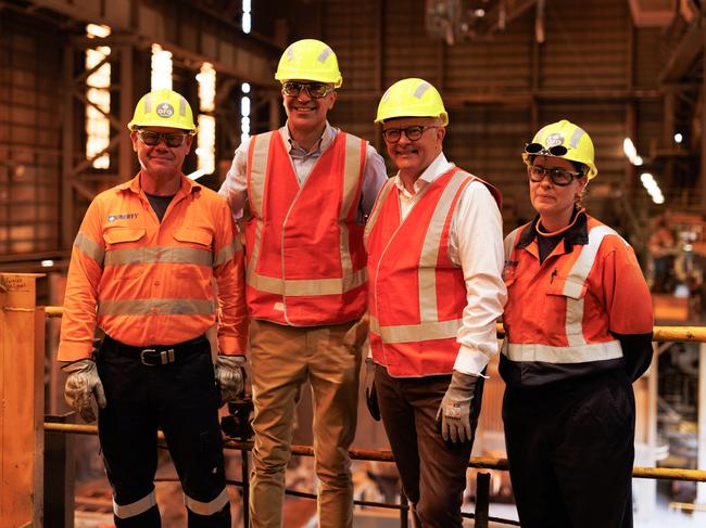 Prime Minister Anthony Albanese (second right) and South Australian Premier Peter Malinauskas (second left) pose for a photograph with workers inside the Whyalla steelworks in Whyalla, South Australia, Wednesday, February 19, 2025. A $2.4 billion government package will keep Whyalla's steelworks running and its debts paid while a new owner is found, after it was placed in administration. (AAP Image/Isabella Ward) NO ARCHIVING