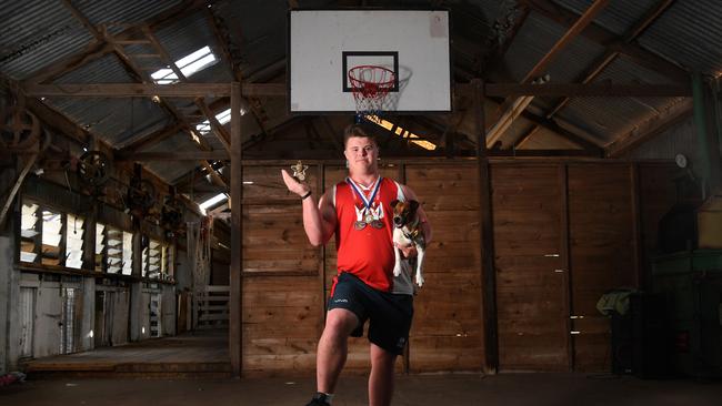 Hugo Taheny with all his medals and dog Dennis in the shearing shed on his family property. Picture: Tricia Watkinson