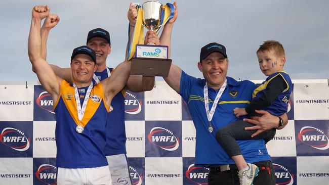 Jake McKenzie, captain Jack Purton-Smith and Marc Bullen hoist the silverware after Deer Park defeated Altona in last year’s WRFL Division 1 grand final. Picture: Local Legends Photography