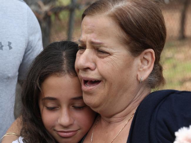 In Black Georgette Abdallah Grandmother of the children killed in the crash on Bettington rd Oatlands with family members .pictures John Grainger