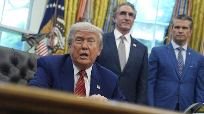 President Donald Trump speaks to reporters after signing executive orders regarding nuclear energy in the Oval Office.