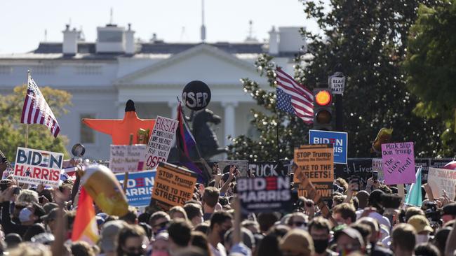 People gather to celebrate Mr Biden’s victory at Black Lives Matter Plaza in Washington. Picture: AFP.