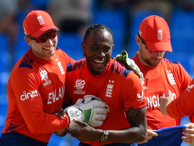 Jofra Archer (2L) and Jos Buttler (L) of England celebrates the dismissal of Pratik Athavale of Oman during the ICC men's Twenty20 World Cup 2024 group B cricket match between England and Oman at Sir Vivian Richards Stadium in North Sound, Antigua and Barbuda, on June 13, 2024. (Photo by Randy Brooks / AFP)