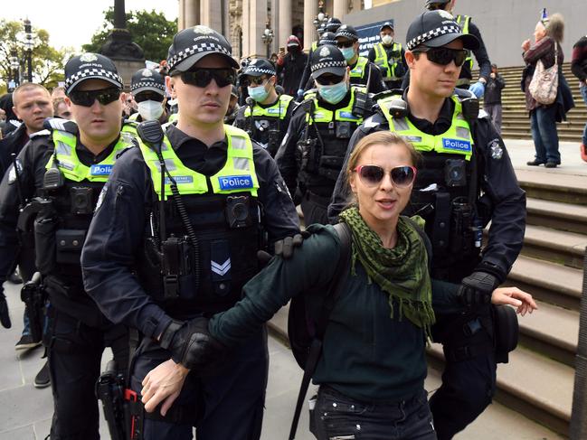 An anti-lockdown protester is placed in a police wagon after being arrested on the steps of Victoria's state parliament in Melbourne on May 10. Picture: AFP