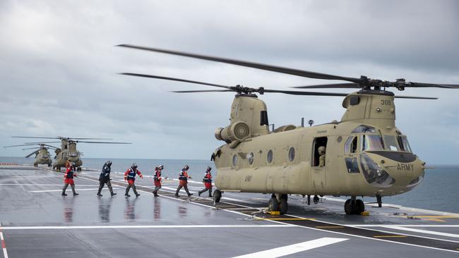 Royal Australian Navy sailors from HMAS Adelaide's flight deck team prepare an Australian Arm CH-47F Chinook helicopter for take off during Operation Tonga Assist 2022. Picture: CPL Robert Whitmore