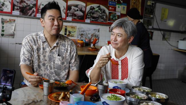 Australian Foreign Minister Penny Wong and her brother James Wong share a meal on Thursday. Picture: Joshua Paul