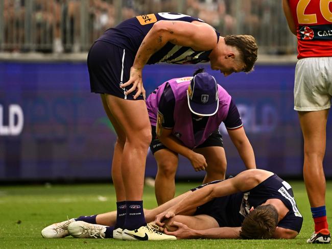 Oscar McDonald clutches at his injured knee. Picture: Daniel Carson/AFL Photos via Getty Images