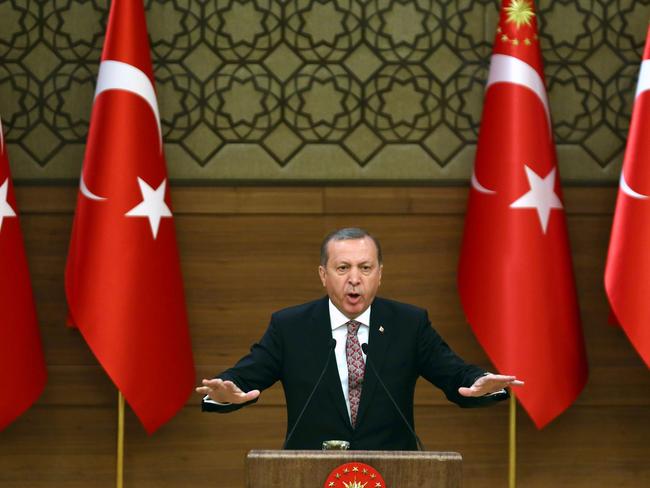 (FILES) This file photo taken on February 10, 2016 shows Turkey's President Recep Tayyip Erdogan delivering a speech during the monthly Mukhtars meeting (local administrators) at the Presidential Complex in Ankara. Turkish President Recep Tayyip Erdogan fired a fresh broadside at the country's top court on March 11, 2016 over the release of two journalists, saying its existence could be in doubt if it did the same thing again. The Constitutional Court -- one of the few Turkish public institutions not fully under Erdogan's control -- last month allowed the release of the Cumhuriyet newspaper's editor-in-chief Can Dundar and Ankara bureau chief Erdem Gul after three months in jail. / AFP PHOTO / ADEM ALTAN