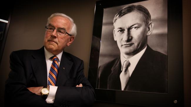 Paul Dibb poses beside a picture of Sir Arthur Tange, who gave him advice as permanent secretary of Defence that he’s now passing on to the independent leads of this new defence review. Pictures: Ray Strange