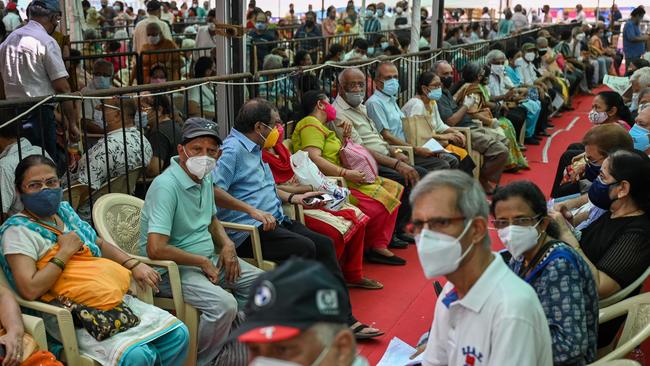 People queue up to receive a dose of a Covid-19 coronavirus vaccine at a vaccination centre in Mumbai.