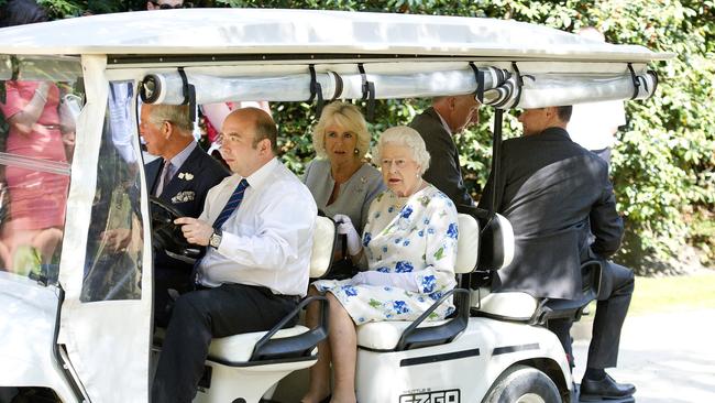 The Queen Elizabeth travels by golf cart with Camilla and Prince Charles at the Coronation Festival, in the grounds of Buckingham Palace, in 2013. Picture: Getty Images.