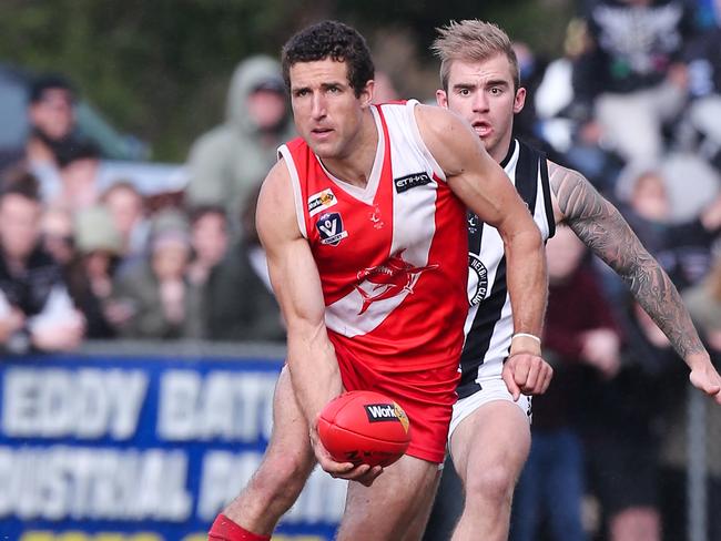 Sorrento's playing coach Troy Schwarze gets a handball away during a best-on-field performance in the 2014 grand final. Picture: David Trend