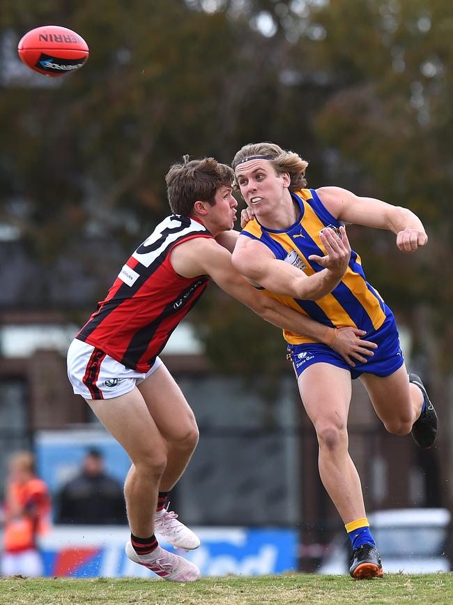 Nathan Oakes gets away a handball for Noble Park.