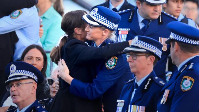 Amy Scott is embraced during a candlelight vigil to honour the victims of the Bondi Junction tragedy at Bondi Beach on Sunday night. Picture: Getty Images