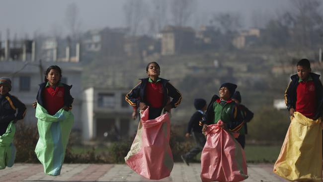 Children play a game of sack race at their school in Bhaktapur, Nepal.