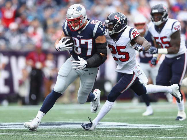 Kareem Jackson (R) tackles New England’s Rob Gronkowski. Picture AFP