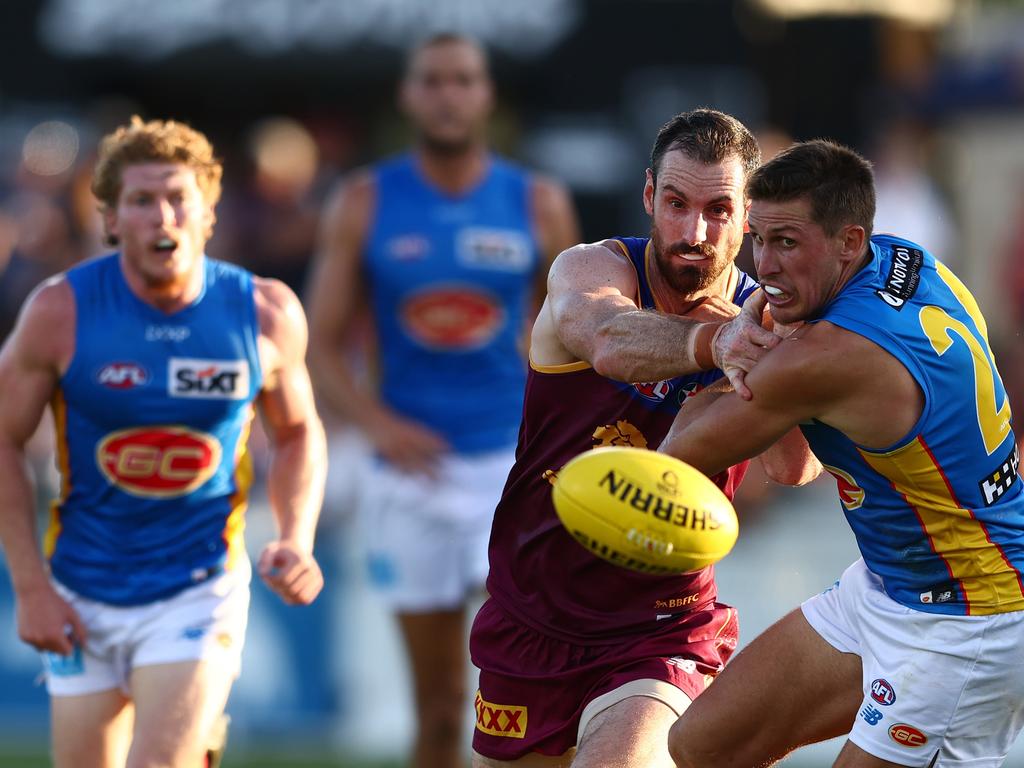 Darcy Gardiner (centre) battles with Gold Coast’s David Swallow in Brisbane’s pre-season win over the Suns. Picture: Chris Hyde/Getty Images