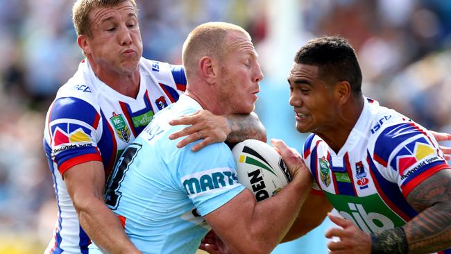 Shark's Luke Lewis tackled by the Newcastle's Trent Hodkinson during the round 5 NRL game between the Cronulla Sharks and the Newcastle Knights at Southern Cross Group Stadium, Cronulla. Picture: Gregg Porteous