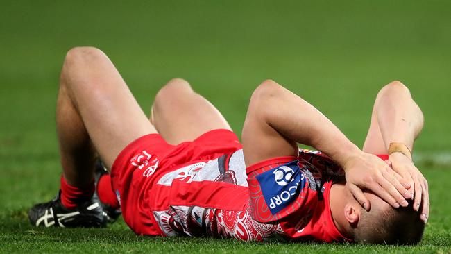 Jackson Ford of the Dragons lays on the field after a collision with Jaxson Paulo of the Rabbitohs. Picture: Cameron Spencer/Getty Images