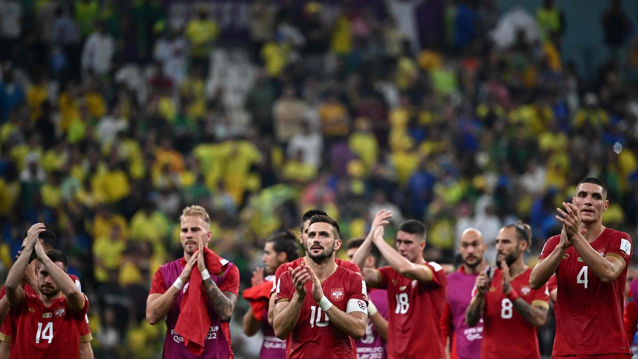 Players of Serbia applaud at the crowd after losing 2-0 to Brazil in the Qatar 2022 World Cup Group G football match between Brazil and Serbia. (Photo by Anne-Christine POUJOULAT / AFP)