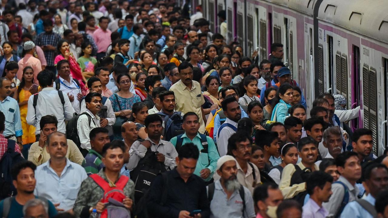 People crowd on platforms as they wait for the train at a station in Mumbai, India. Picture: AFP