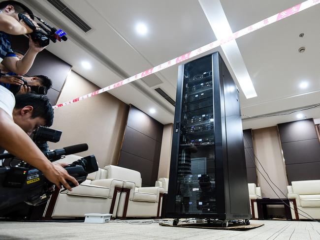 Media filming an artificial intelligence machine named AI-MATHS in Chengdu, in China's southwest Sichuan province.