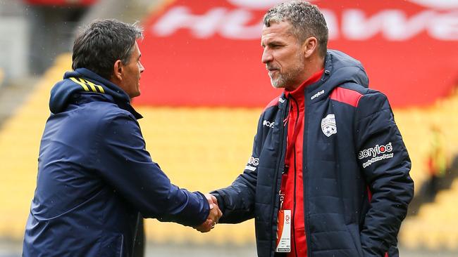 Rado Vidosic shakes hands with Adelaide coach Marco Kurz.