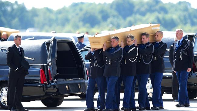 Dutch military personnel carry a coffin containing the remains of the victims of MH17. Picture: AFP