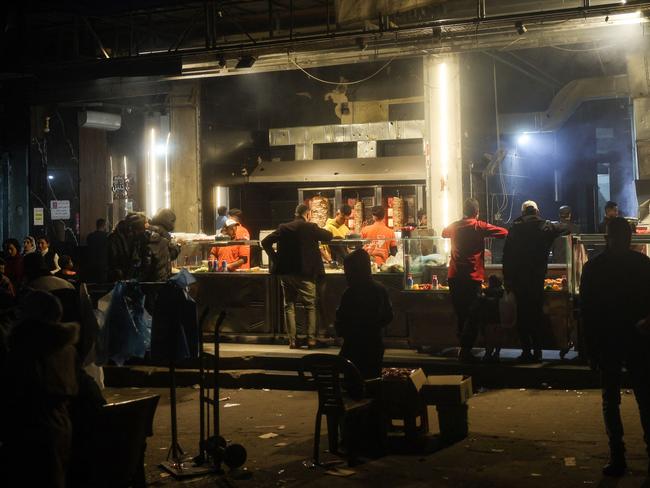 Palestinians gather in front of a sandwich shop. Picture: AFP