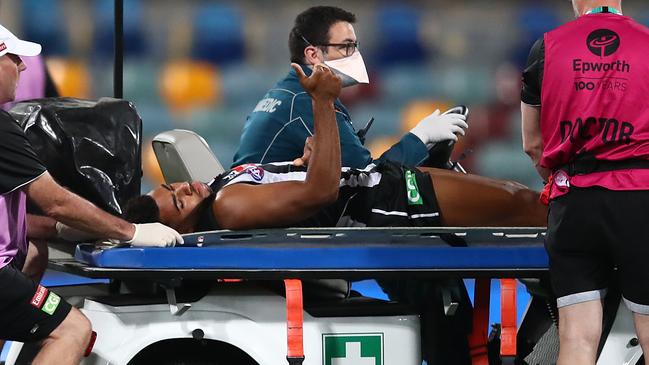 Isaac Quaynor is taken off the ground injured. (Photo by Jono Searle/AFL Photos/via Getty Images)