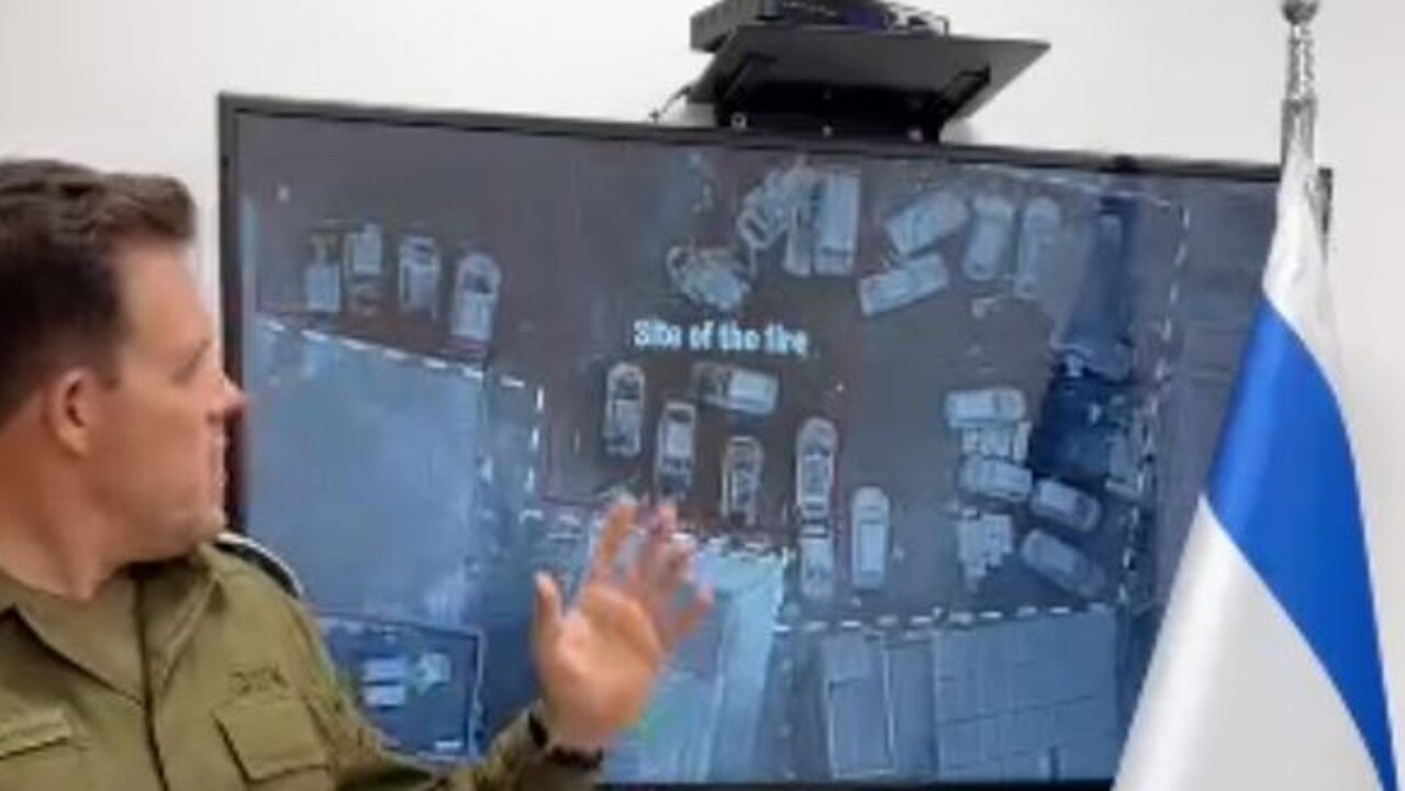 Israeli Defense Forces spokesperson Jonathan Conricus with a satellite image of the site of the explosion.