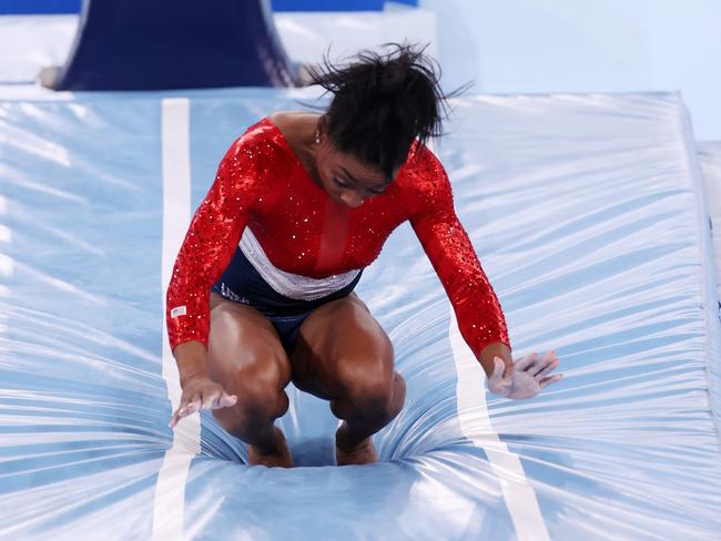 Simone Biles of Team United States stumbles upon landing after competing in vault during the Women's Team Final on day four of the Tokyo 2020 Olympic Games.