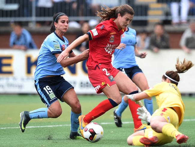 Leena Khamis (left) of Sydney competes for the ball with Cheyenne Hammond (centre) and Eliza Campbell of United during the round 4 W-League match between Sydney FC and Adelaide United at Seymour Shaw Park in Sydney on Sunday, Nov. 27, 2016. (AAP Image/Paul Miller)