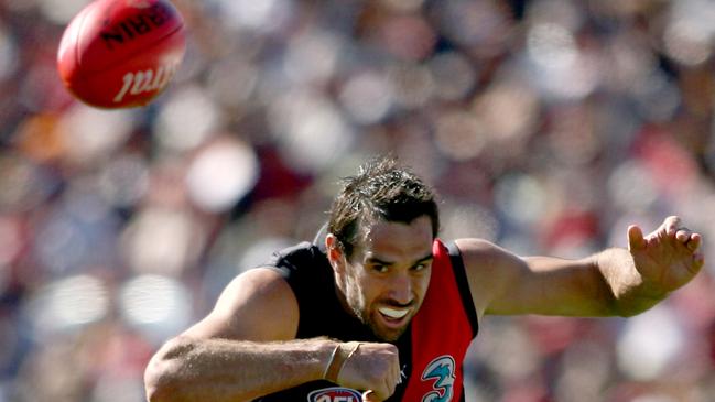 Scott Lucas launches Essendon forward on his trusty left boot.