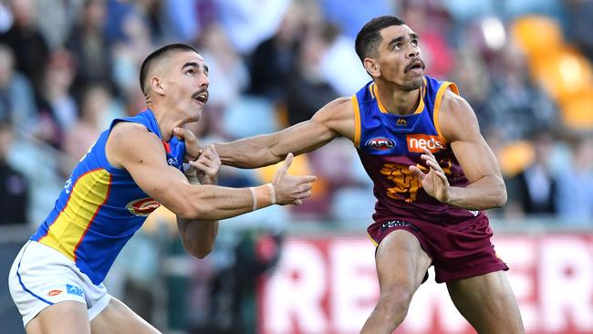 Charlie Cameron (right) outpositions Gold Coast’s Jacob Dawson (left) in a marking contest on Saturday. Picture: AAP Image/Darren England