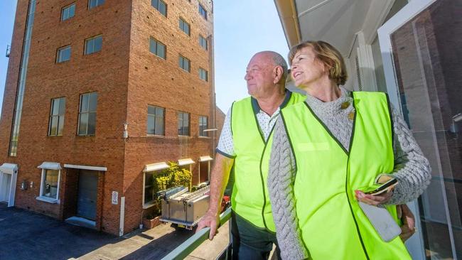 Les and Jan McGill look at the restored brewery tower and the Industrial Village after a massive repair job to repair the roof and remove asbestos after a storm last year. Picture: Adam Hourigan