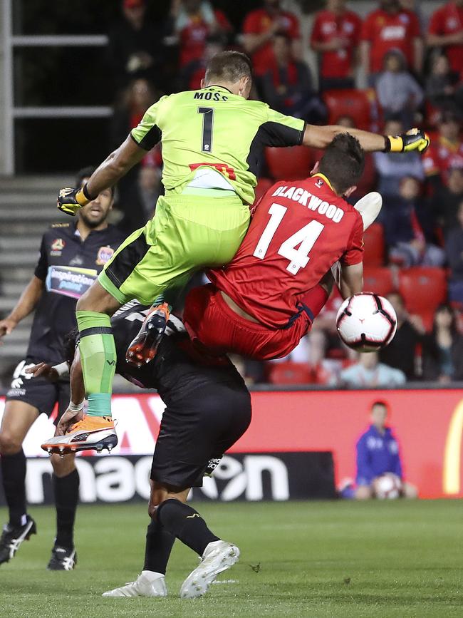 Adelaide United’s George Blackwood breaks his collarbone in a round-two clash with Newcastle Jets goalkeeper Glen Moss. Picture: Sarah Reed