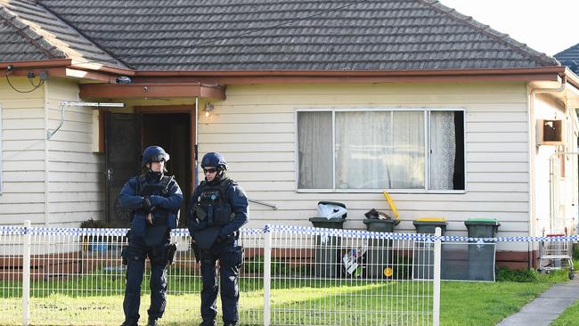 Police stand guard at a property in Pascoe Vale. Picture: Jake Nowakowski