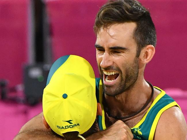 Damien Schumann (right) and Christopher McHugh of Australia celebrate winning the Men's gold medal Beach Volleyball match against Canada during the XXI Commonwealth Games on the Gold Coast, Australia, Thursday, April 12, 2018. (AAP Image/Darren England) NO ARCHIVING, EDITORIAL USE ONLY