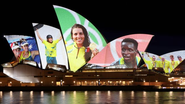 Olympians Mariafe Artacho del Solar, Taliqua Clancy, Keegan Palmer, Jessica Fox, Peter Bol, Alexander Purnell, Spencer Turrin, Jack Hargreaves and Alexander Hill projected on the sails of the Sydney Opera House.