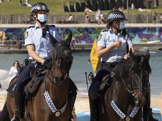 SYDNEY, AUSTRALIA - AUGUST 15: Mounted Police patrol at Bondi Beach as part of public health order compliance operations on August 15, 2021 in Sydney, Australia. The whole state of New South Wales is now under stay-at-home orders as NSW health authorities work to contain an outbreak of the highly contagious delta COVID-19 strain. From Monday 16 August, the 10km travel rule in Greater Sydney will be reduced to 5km, limiting residents to a 5km radius from their homes. New spot fines for breaching COVID-19 rules will also come into effect including $5000AUD fines for quarantine breaches and $3000AUD for travel breaches.  (Photo by Getty Images)