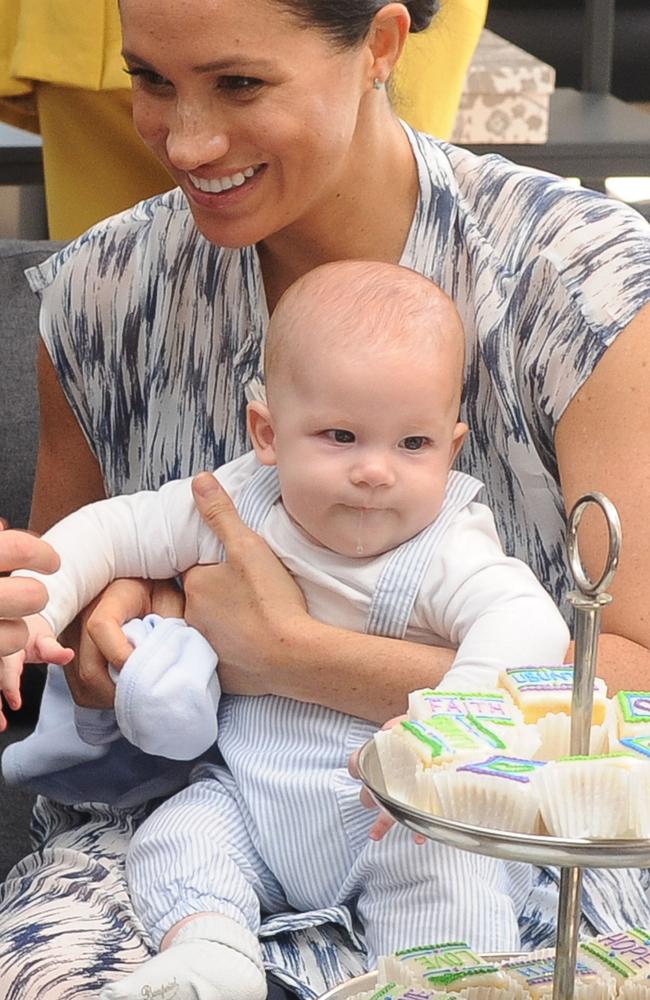 Archie eyes up the teacakes and Archbishop Desmond Tutu’s foundation. Picture: HENK KRUGER / POOL / AFP.