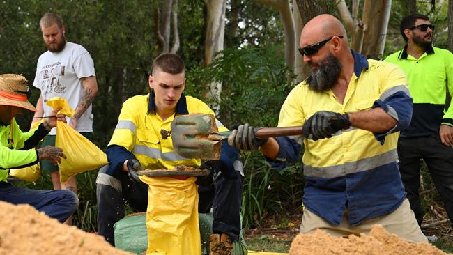 BRISBANE, AUSTRALIA - MARCH 05: Brisbane City Council workers fill sandbags at a Lota depot on March 05, 2025 in Brisbane, Australia. Tropical Cyclone Alfred is expected to make landfall in southeast Queensland and northern NSW as a Category 2 storm, marking the first time a cyclone has directly hit the region in over 50 years. The storm is forecast to bring damaging winds, heavy rainfall, and potential storm surges, prompting authorities to urge residents to prepare for significant impacts, including flooding and power outages. (Photo by Albert Perez/Getty Images)