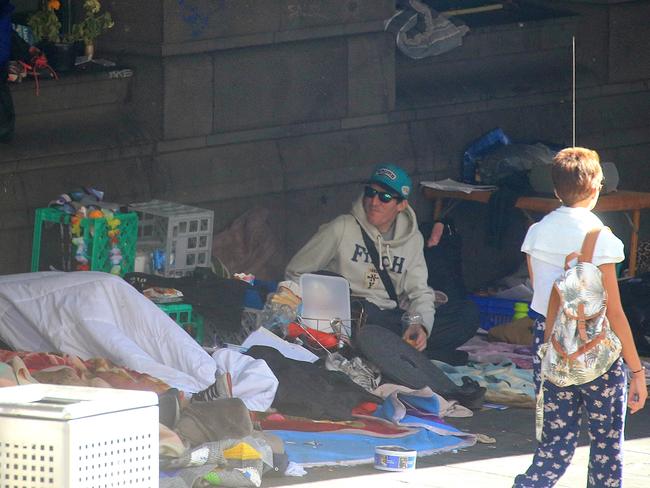 Homeless people outside Flinders St station. Picture: Mark Stewart